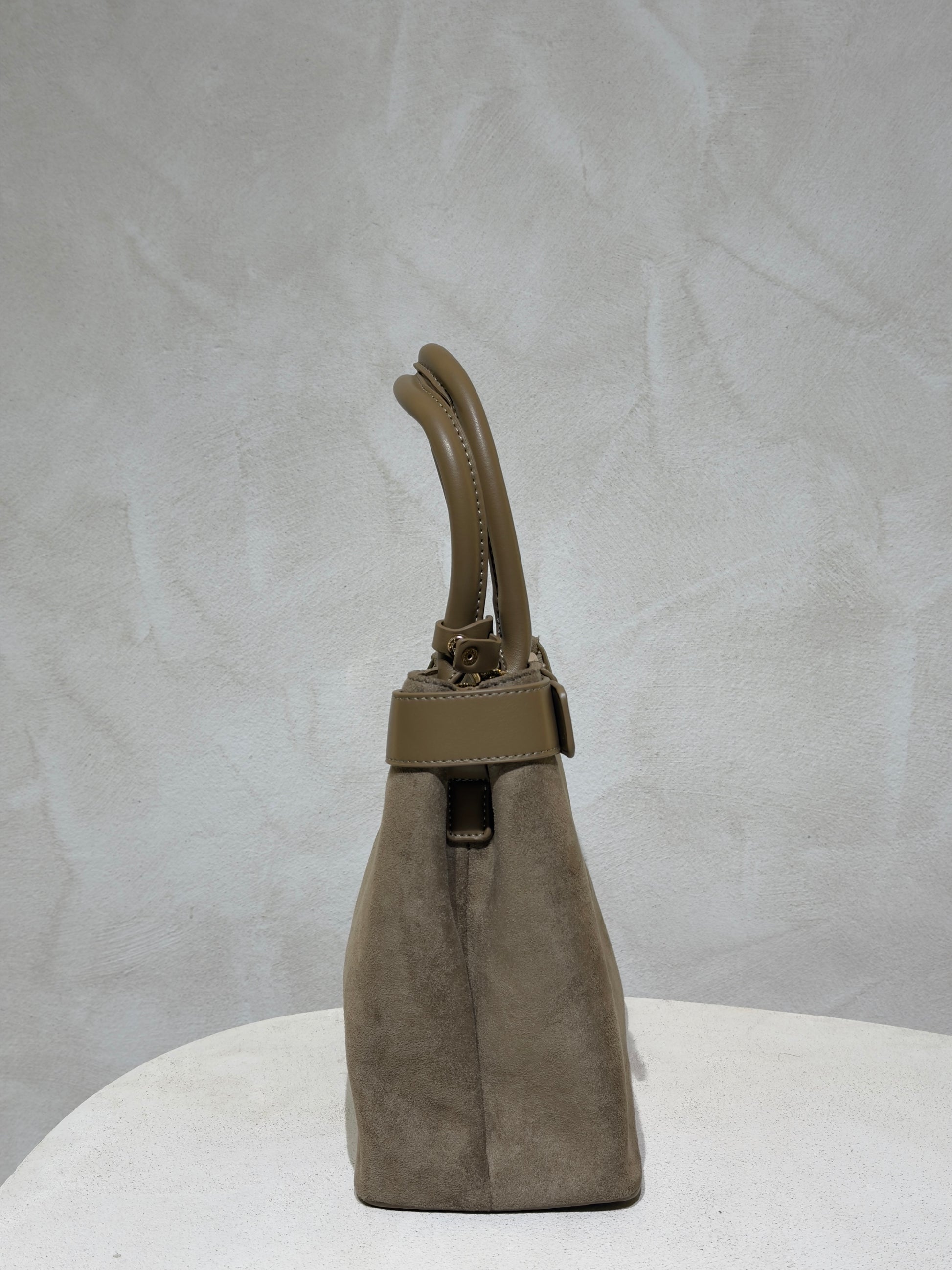 Découvrez le Sac à main Emi, l'accessoire incontournable qui allie élégance et sophistication. Confectionné en daim doux et velouté, ce sac séduira par sa texture raffinée. Rehaussé d'une ceinture en cuir véritable à la taille, il affiche un style classique et intemporel. Les anses en cuir premium garantissent confort et durabilité pour un port quotidien sans compromis. Un sac polyvalent qui transforme chaque tenue en look soigné et chic.

Découvrez l'élégance intemporelle avec ce sac à main en velours soph