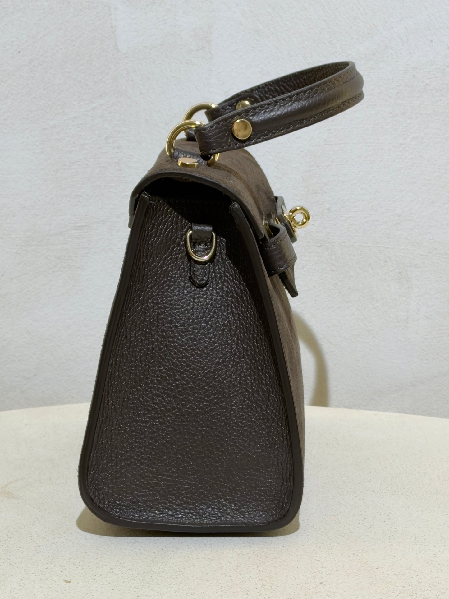 Découvrez l'élégance intemporelle avec ce sac à main d'exception. Confectionné en daim premium, il incarne le raffinement avec ses lignes épurées inspirées des plus grands classiques de la maroquinerie. Sa structure impeccable et sa matière noble en font un accessoire de prestige qui sublimera vos tenues les plus sophistiquées. Un investissement incontournable pour celles qui ne font aucun compromis sur la qualité et le style.